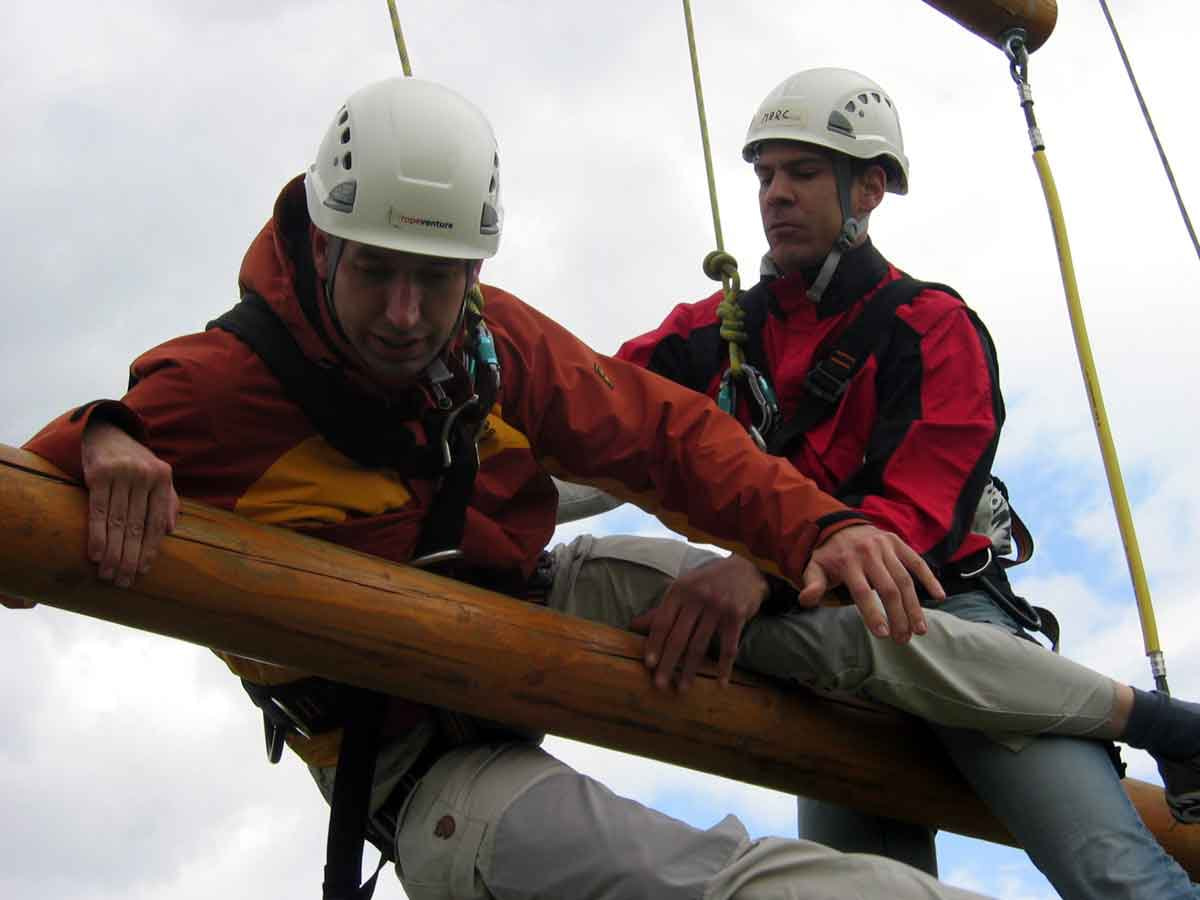 teambildende-Massnahmen-Wissenschaft-Dangle-Duo Auf dem Dangle Duo begegnen sich zwei Mitarbeiter bei einer teambildenden Massnahme im Unternehmen auf ungewohnte Weise.